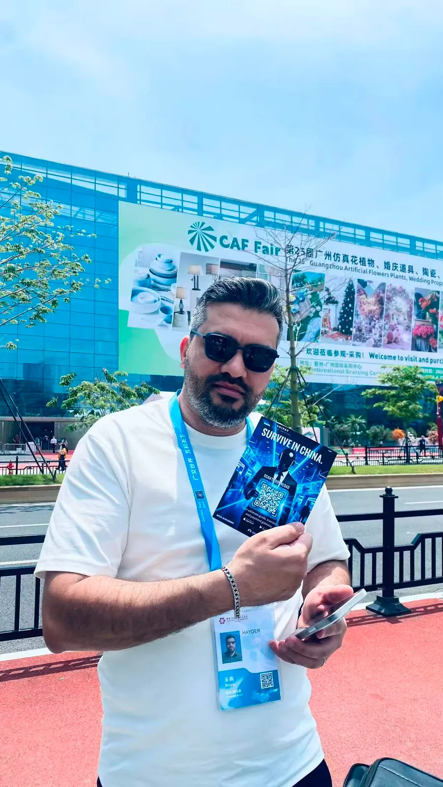 A visitor beside Canton Fair signage