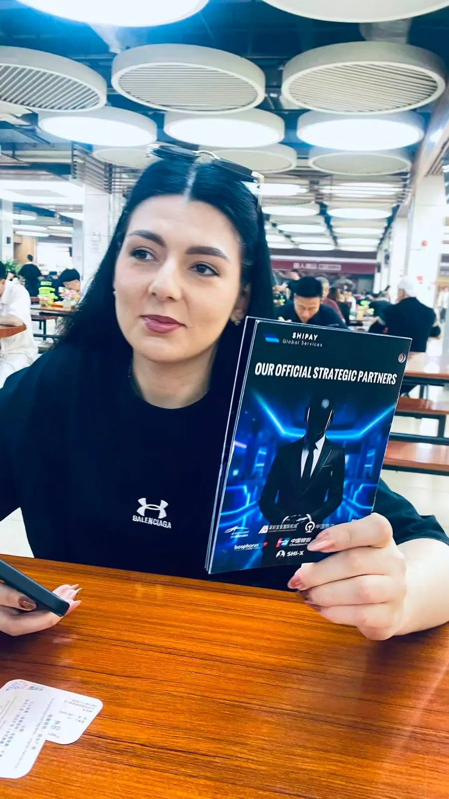 A visitor holding event information at Canton Fair
